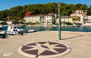 a star sign on a dock next to the water at Three-Bedroom Apartment In Povlja in Povlja