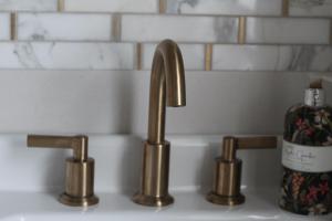 a sink with two faucets and a bottle of soap at The Fairways, CastleBlayney in Castleblayney