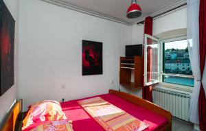 a small bedroom with a bed and a window at Three-Bedroom Apartment In Povlja in Povlja