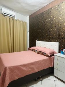 a bedroom with two beds with pink sheets at Prédio 320 São Brás in Belém +11 photos
