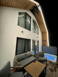 a living room with a couch and chairs and a table at Altitude 2 Matra in Mátraszentimre