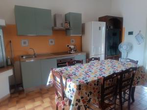a kitchen with a table with a table cloth on it at Cascina Vittorio, Relax in campagna con barbecue vicino Gallipoli in Noha