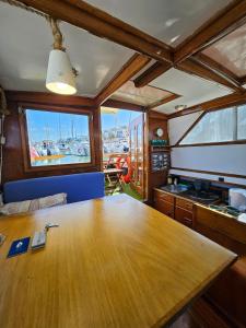 a dining room with a wooden table in a boat at Lisboa Barco Corleone in Lisbon