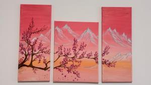 four paintings of a tree and mountains on a wall at Hostel Koral in Szczecin