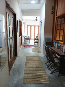 a hallway with a table and chairs and a desk at Serene Mountain Retreat in KL - Entire House for Rent in Kampong Kelang Gates Baharu