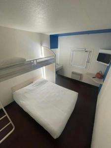 a small room with a bunk bed and a mirror at Unisotel Colmar Parc Des Exposition EX F1 in Colmar