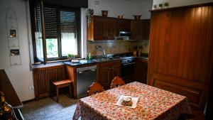 a kitchen with a table with a table cloth on it at Casa Sala in Castionetto di Chiuro