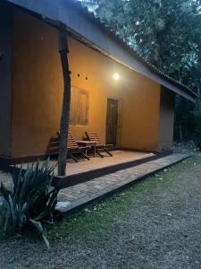 a house with a porch with chairs and a table at Emma safari udawalawa in Udawalawe