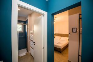 a small room with a bed and a bathroom at Show MI Rooms Milano - Rho Fiera & San Siro - Free Parking in Milan