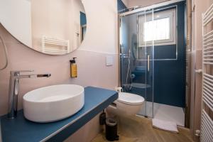 a bathroom with a sink and a toilet and a mirror at Show MI Rooms Milano - Rho Fiera & San Siro - Free Parking in Milan +52 photos
