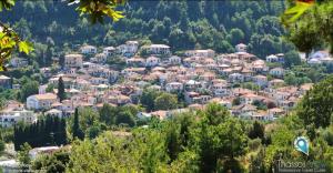 a village on a hill with houses and trees at Kunada home in Potamiá