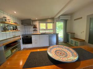 a kitchen with a large bowl on a wooden table at Ferienhaus im Grünen mit Weitblick in Gersheim