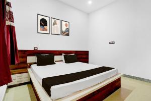 BilāspurにあるHotel O Pushkar And Restaurantのベッドルーム1室(大型ベッド1台、壁に4枚の写真付)