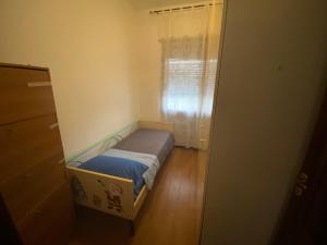 a small bed in a small room with a window at Casa Tranquilla vicino al Centro in Padova