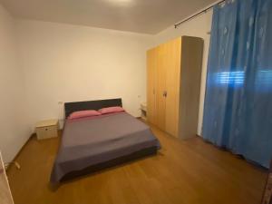a small bedroom with a bed and a wooden floor at Casa Tranquilla vicino al Centro in Padova