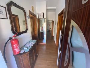 a hallway with a mirror and a red fire hydrant at Casa Tranquilla vicino al Centro in Padova