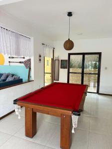 a pool table in the middle of a room at Pousada Costa dos Corais in Mangaratiba