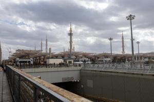 a bridge with a building with mosques in the background at Emaar Elite Al Madina Hotel in Medina