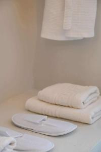 two white towels sitting on a counter in a bathroom at Skalia Mountain & Sea Suites in Skaliá