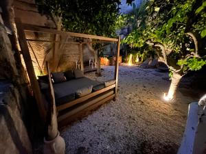 a bedroom with a canopy bed in a garden at night at Rada room&suite in Favignana