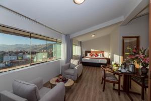 a hotel room with a bed and a room with a view at Quechua Plaza Hotel in Cusco +72 photos