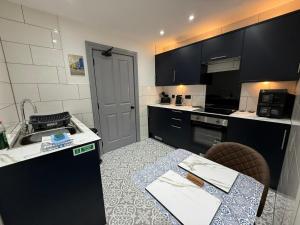 a small kitchen with a sink and a table at The Lookout in Tobermory