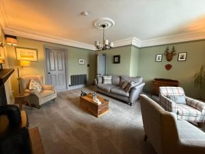 a living room with couches and a coffee table at The Lookout in Tobermory