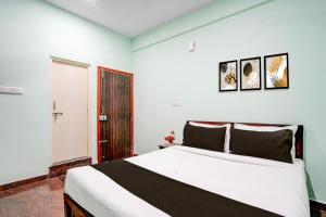 a bedroom with a large bed in a room at Hotel O Nature Comforts in Bengaluru