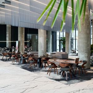 a group of tables and chairs in front of a building at Zyra Blue Heart Pool & Spa in Năvodari