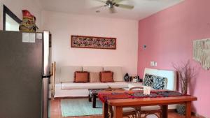 a living room with a couch and a table at House by the beach Casa Murmullos in Isla Mujeres