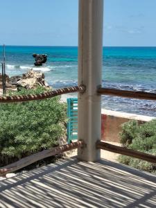 a view of the ocean from a balcony at House by the beach Casa Murmullos in Isla Mujeres +30 photos