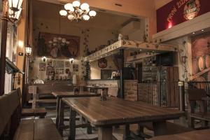 a restaurant with wooden tables in a room at Hotel Victor in Prague