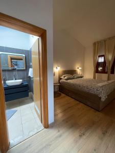 a bedroom with a bed and a sink at Kuća za odmor in Sveti Filip i Jakov