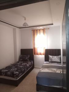 Ένα ή περισσότερα κρεβάτια σε δωμάτιο στο Appartement pré aéroport et océan