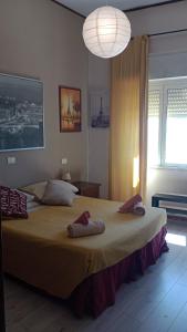a bedroom with a large bed with towels on it at Suite beachfront near the station and Port, 5 beds in Civitavecchia