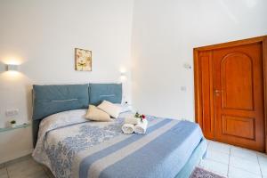 a bedroom with a blue bed with towels on it at Villa Mare in Amalfi