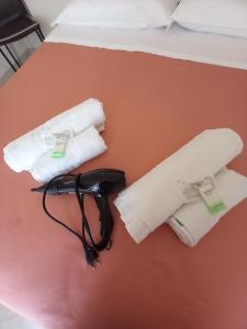 a bed with two rolled up towels on a table at Casa Angelo in Ventimiglia