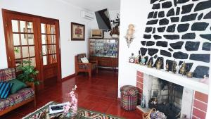 a living room with a stone fireplace in a house at Casa Quinta da Adega do Chão - Vale do Douro in Lamego