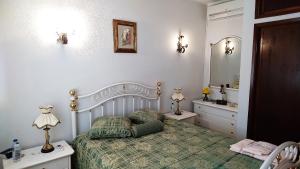 a bedroom with a bed and a sink and a mirror at Casa Quinta da Adega do Chão - Vale do Douro in Lamego