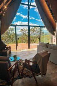 a living room with a couch and a large window at Kos Hytte in Rio Acima +49 photos