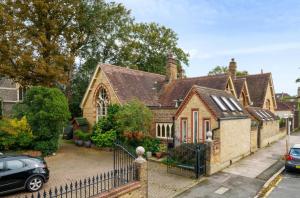 a house with a fence in front of it at School Cottage conversion in Grove Park