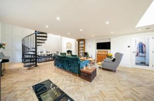 a living room with a blue couch and a staircase at School Cottage conversion in Grove Park
