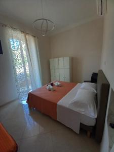 a bedroom with a large bed and a window at Casa Angelo in Ventimiglia
