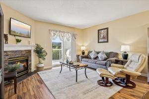a living room with a couch and a fireplace at WP431 Private Sunsets in Pigeon Forge