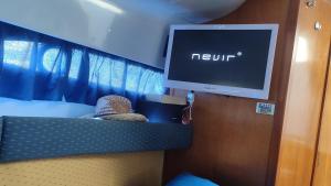 a tv in a room with a bed with a new unit at Long term Golf del Sur in San Miguel de Abona