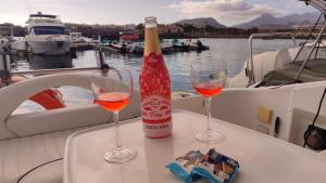 two glasses of wine on a table on a boat at Long term Golf del Sur in San Miguel de Abona