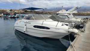 a white boat docked at a dock in the water at Long term Golf del Sur in San Miguel de Abona +4 photos