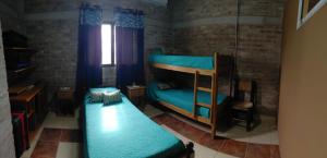 a bedroom with two bunk beds and a window at Cumbres del Sol in Albardón
