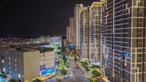 a view of a city at night with tall buildings at Shi House - Modern Apartment Vinhomes Grand Park - Căn Hộ Studios in Gò Công