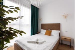 a bedroom with a bed with two pillows on it at Sika Prestige Apartment - cazare premium Arad - self check-in in Arad